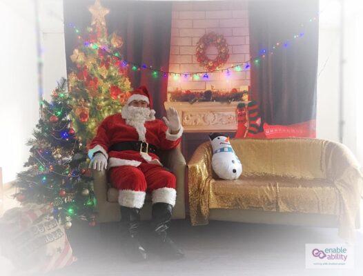 Santa sat on a seat with Christmas trees and lights around