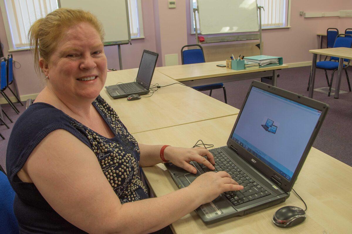 Rachel Hannon using a laptop as part of her PC service to local residents